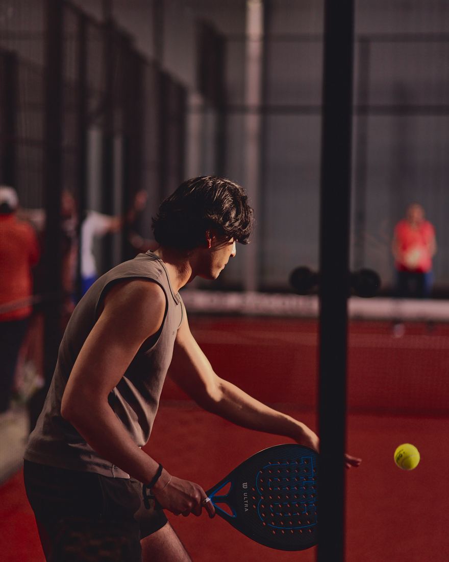 A player lining up a shot on the red court